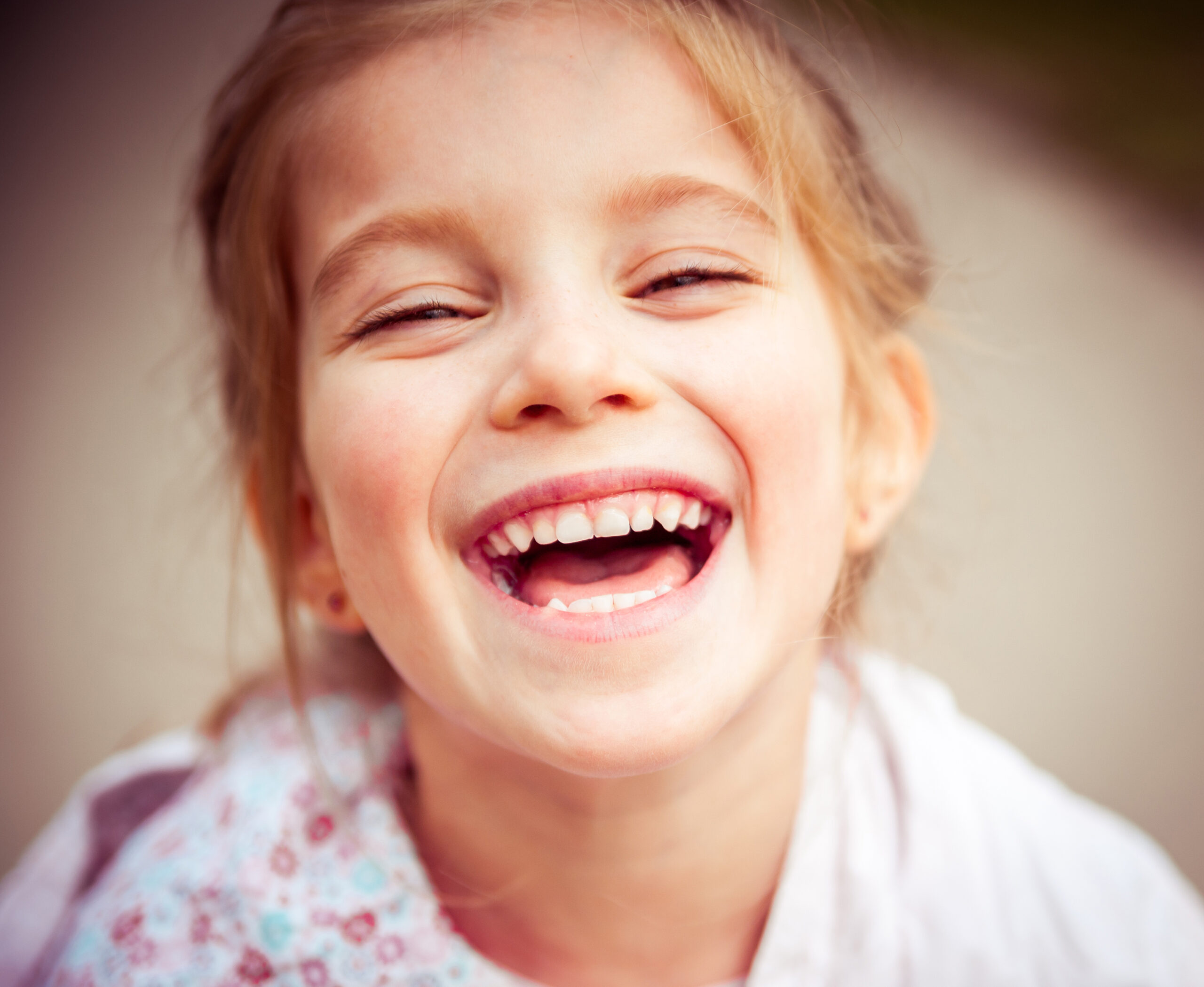 Close up portrait of young girl laughing